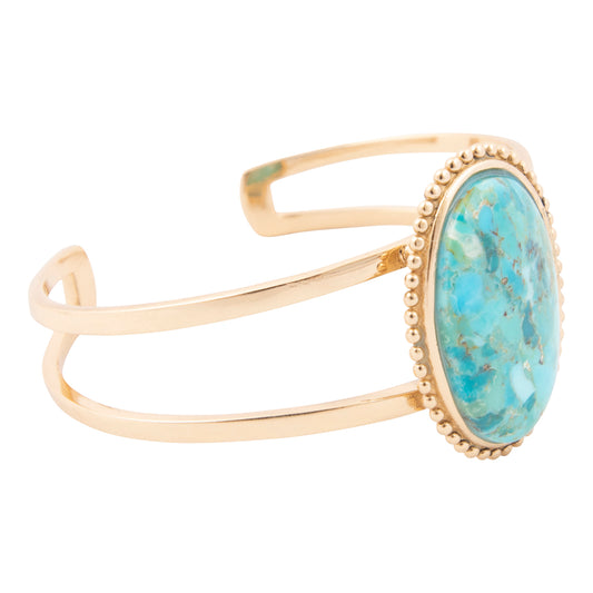 Gold bracelet with a turquoise stone on a white background