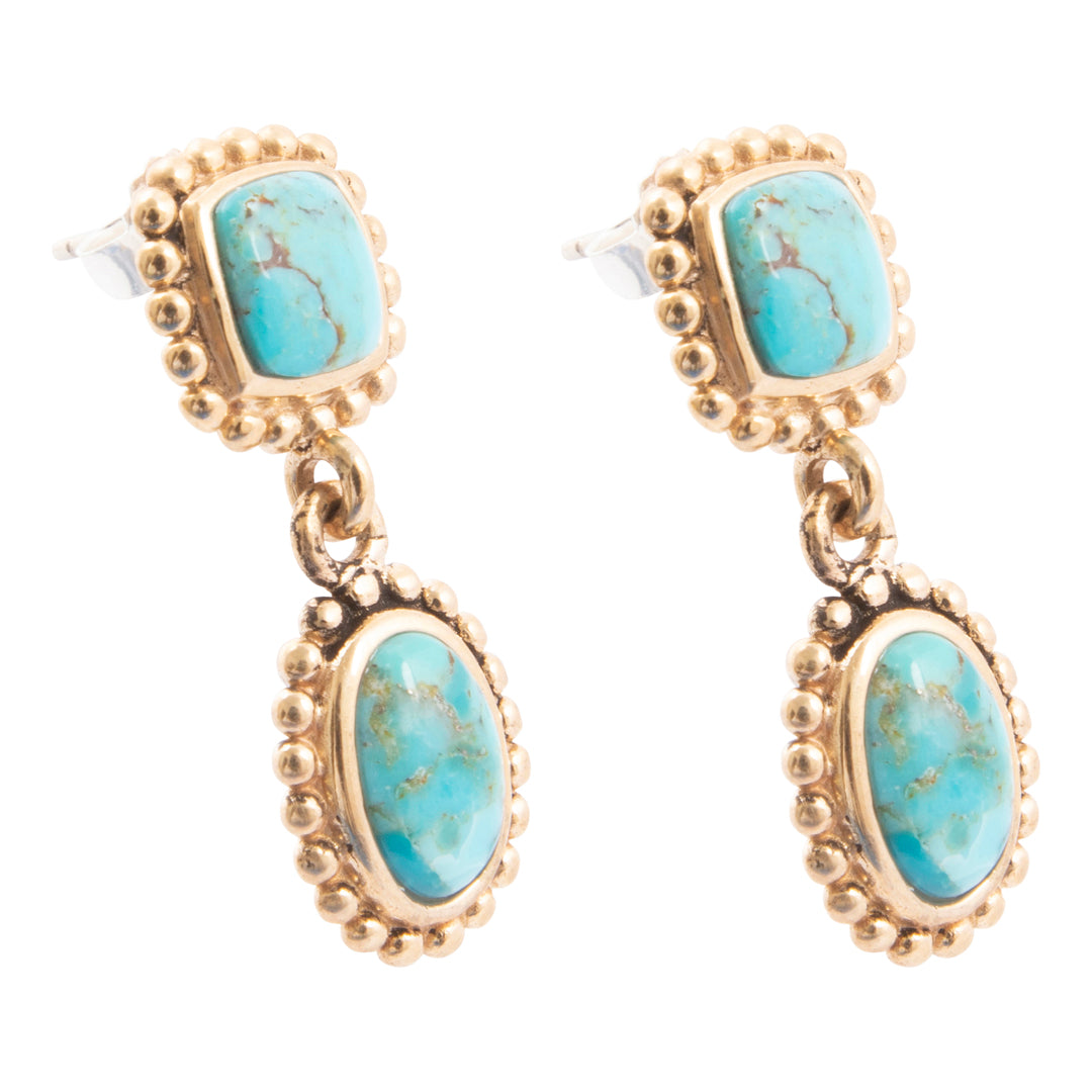 Gold earrings with turquoise stones on a white background