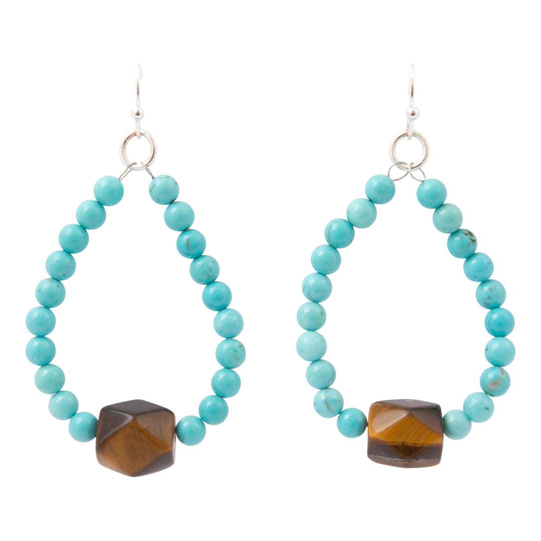 A pair of drop earrings featuring a large teardrop-shaped arrangement of turquoise-blue beads with a faceted brown tiger's eye bead at the bottom, suspended from silver fishhook wires on a white background.