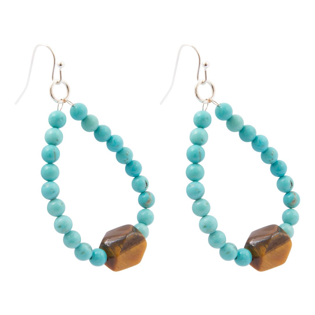 A pair of dangling earrings made of small turquoise-blue beads forming an open teardrop shape, with a faceted brown tiger's eye stone at the bottom and silver fishhook ear wires, shown on a plain white background.