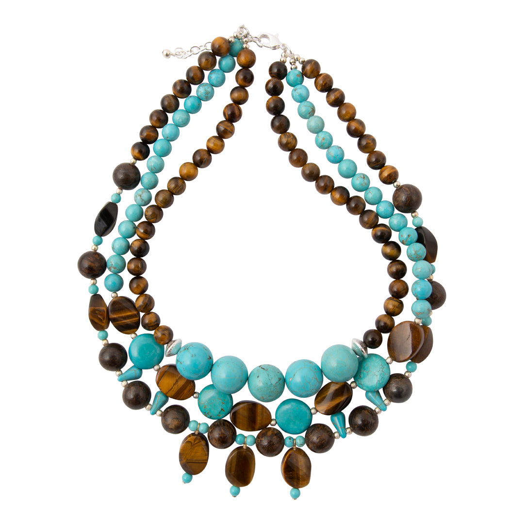 A multi-strand statement necklace featuring turquoise, dark brown, and tiger's eye beads, displayed on a clean white background.