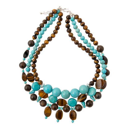 A multi-strand statement necklace featuring turquoise, dark brown, and tiger's eye beads, displayed on a clean white background.