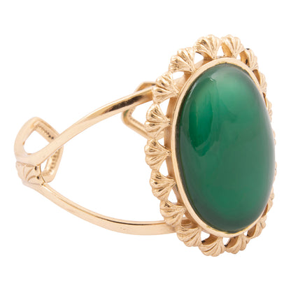 Gold ring with a green gemstone on a white background