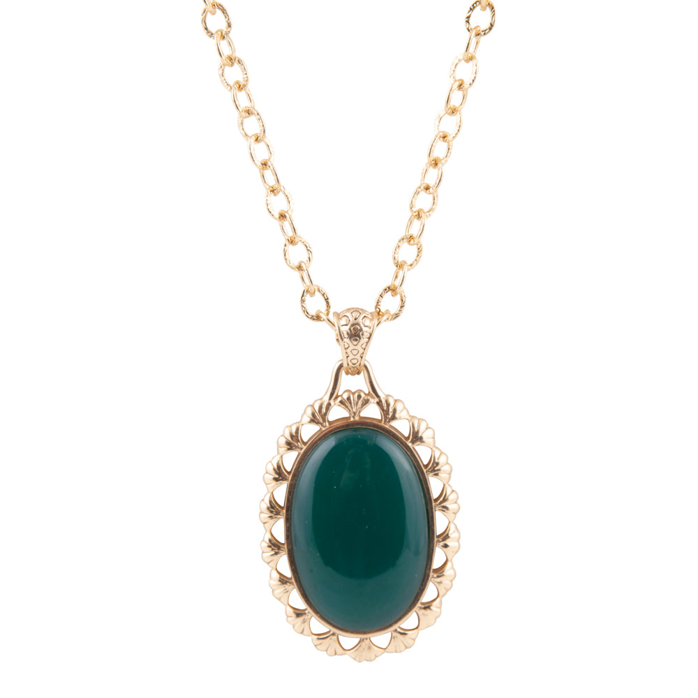 Gold necklace with a green pendant on a white background