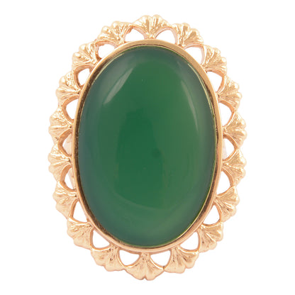 Gold ring with a green stone on a white background