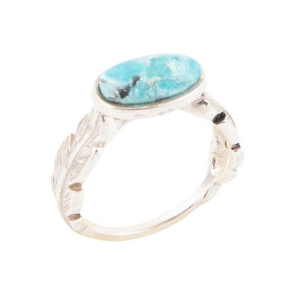 Silver ring with a turquoise stone on a white background
