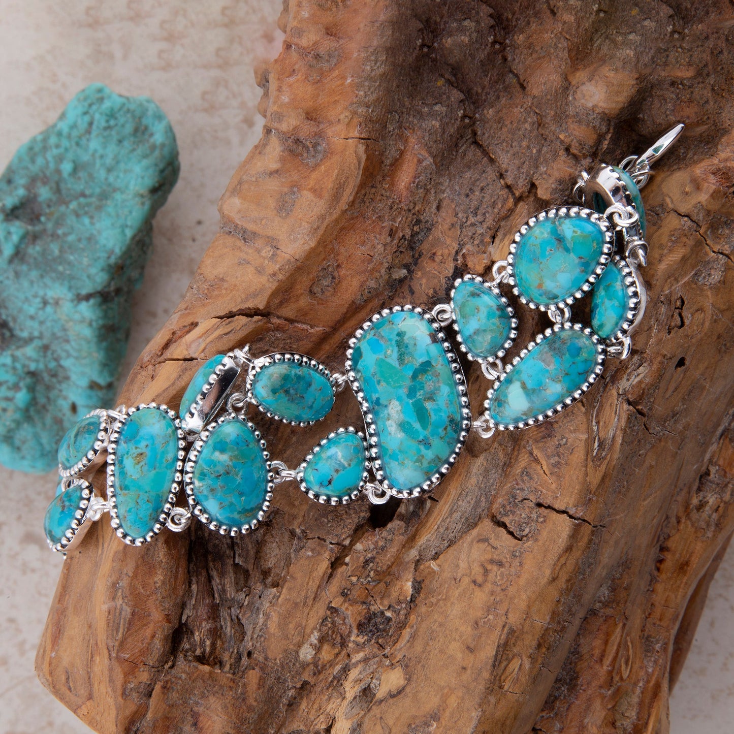 Turquoise bracelet with silver accents on a wooden surface