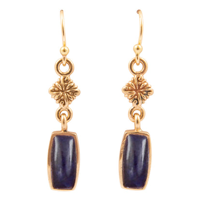 Gold earrings with blue stones on a white background