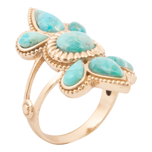 Gold ring with turquoise stones on a white background