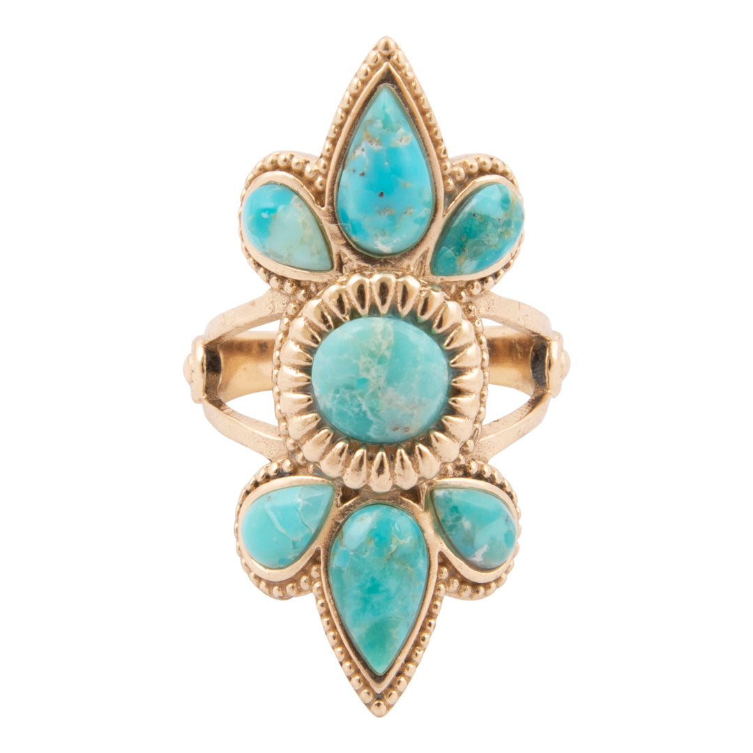Gold ring with turquoise stones on a white background