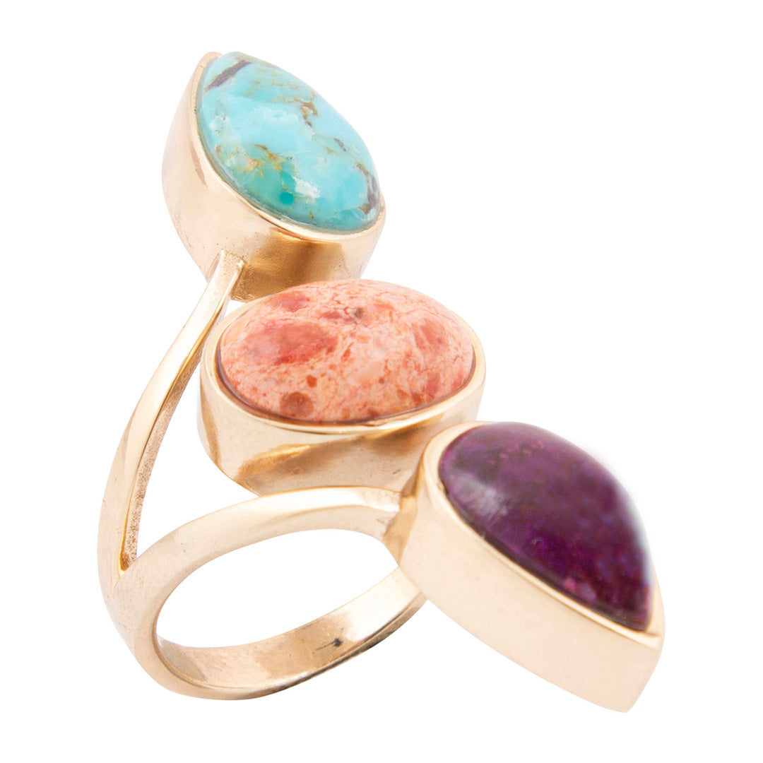 Gold ring with three colorful stones on a white background