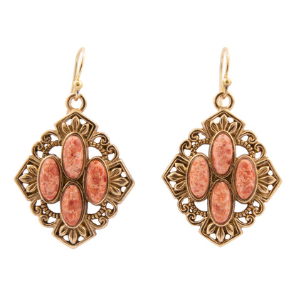 Pair of ornate earrings with pink stones on a white background