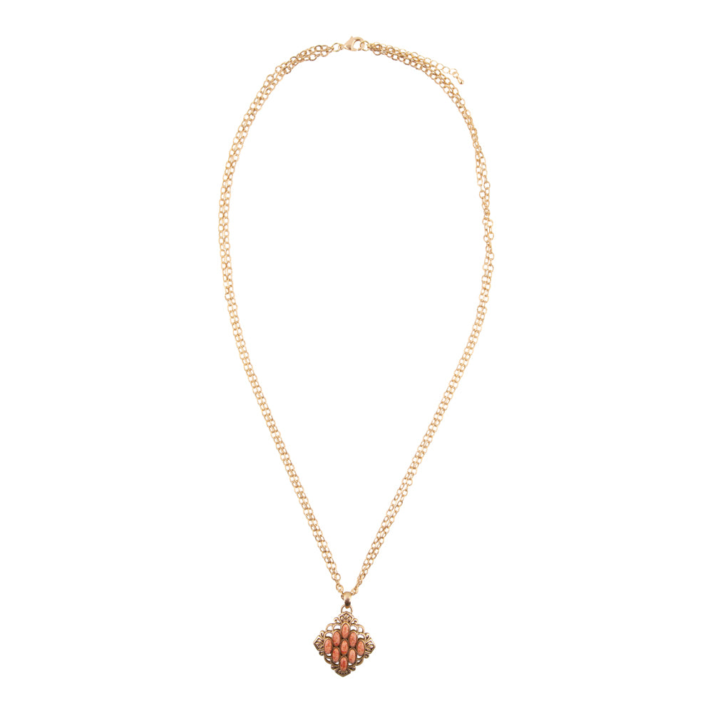 Gold necklace with a decorative pendant on a white background