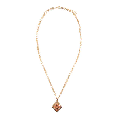 Gold necklace with a decorative pendant on a white background