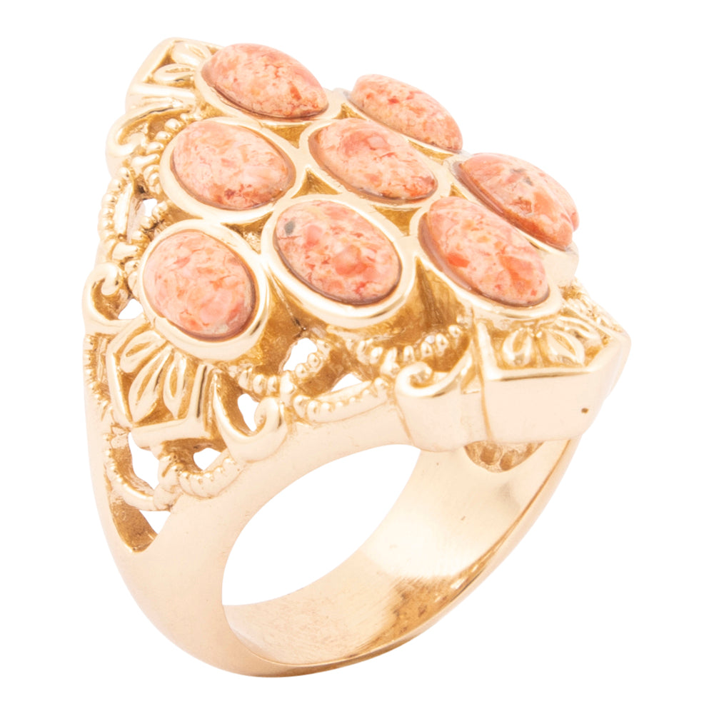 Gold ring with pink stones on a white background