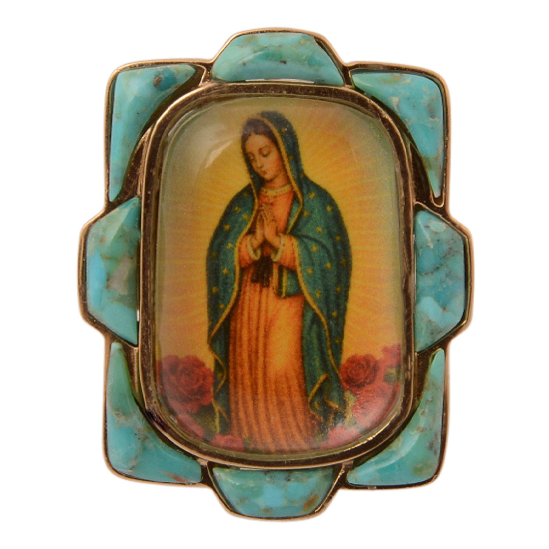 Decorative brooch with an image of a religious figure in a decorative frame on a white background