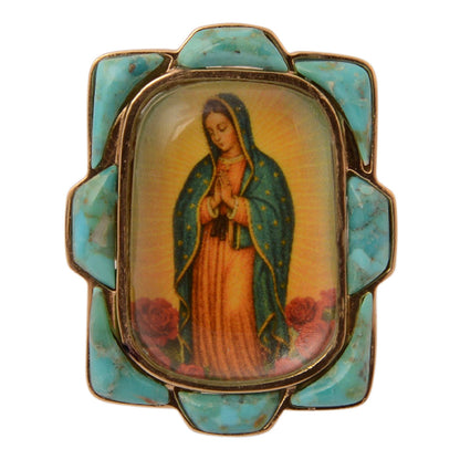 Decorative brooch with an image of a religious figure in a decorative frame on a white background