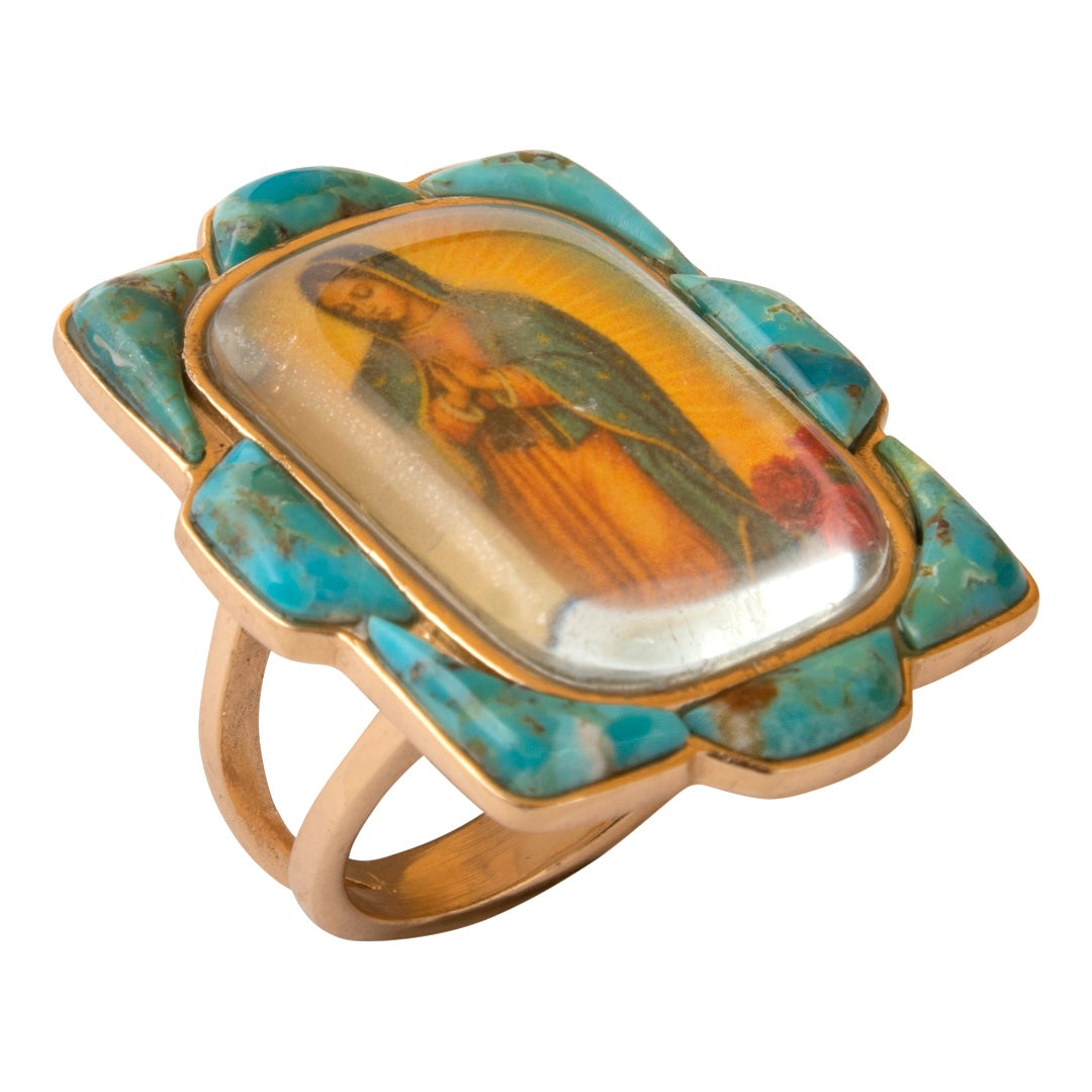 Ring with a turquoise and gold setting featuring an inset portrait on a white background