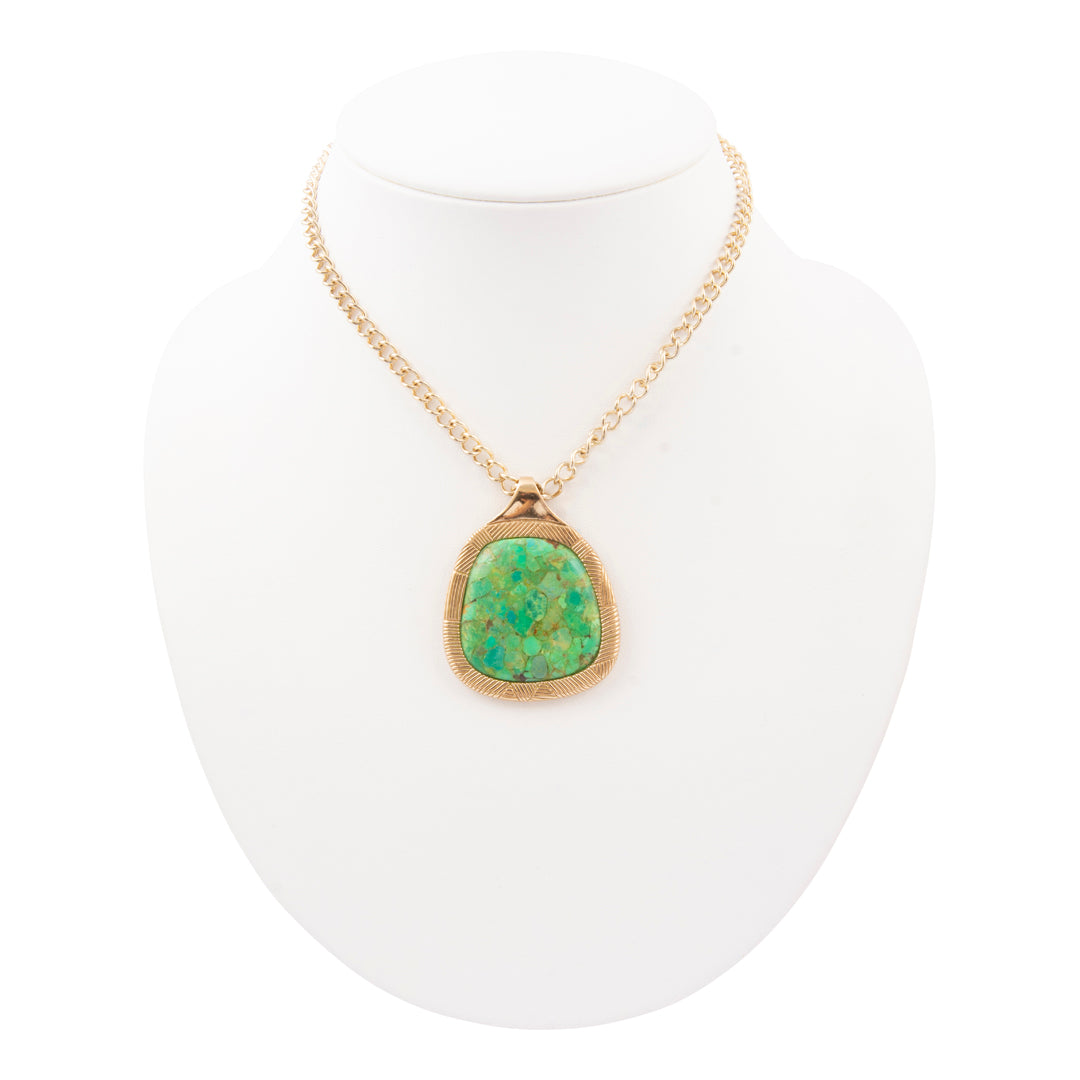 Necklace with a green pendant on a white mannequin
