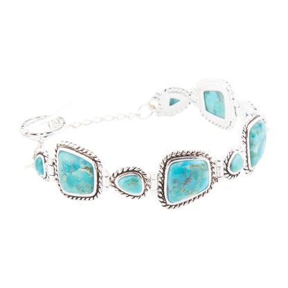 Turquoise stone bracelet with silver accents on a white background