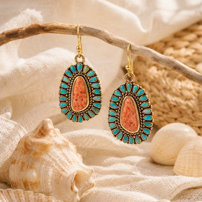 Sedona blue turquoise and orange sponge coral gold-tone earrings displayed against a styled background