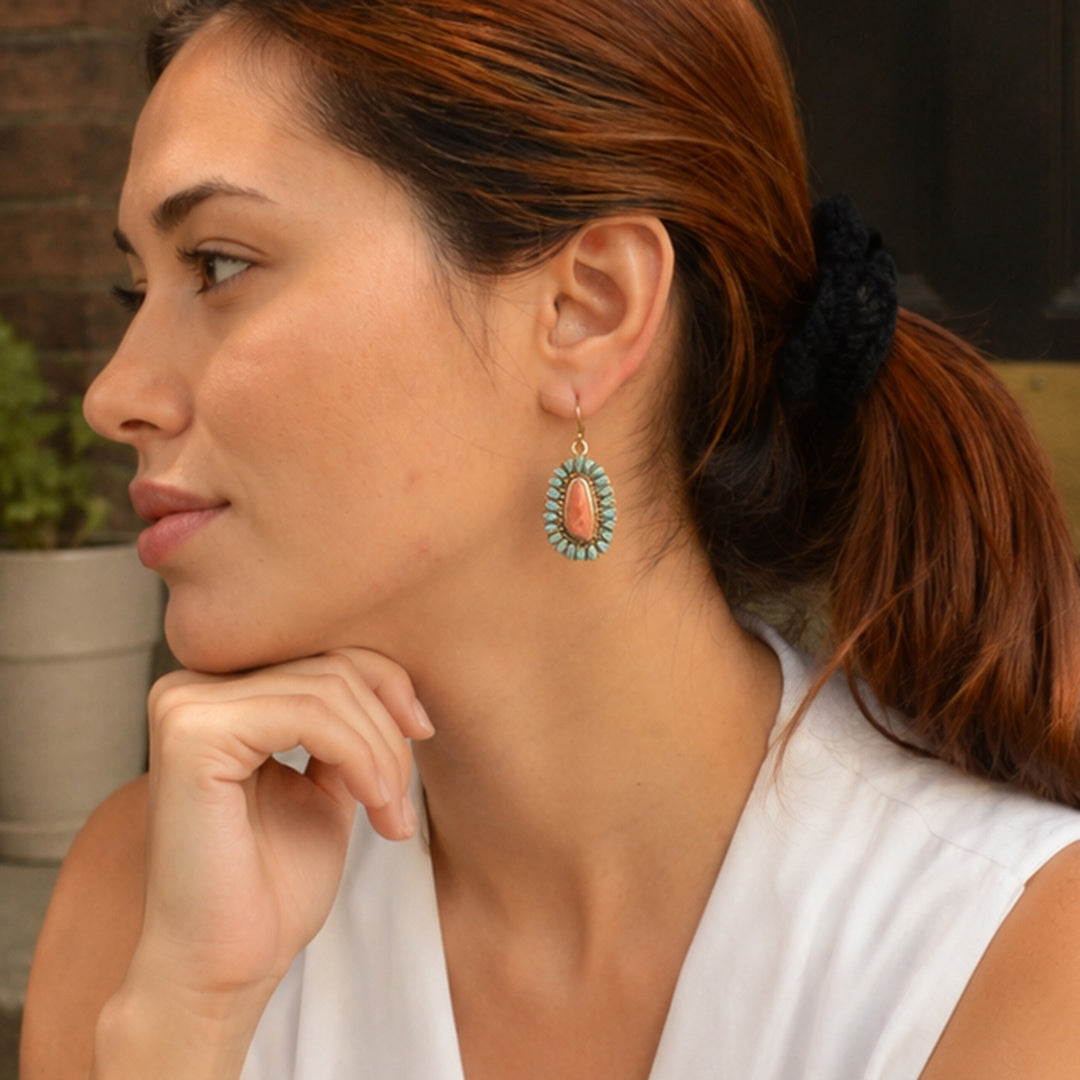 Model wearing Sedona blue turquoise and orange sponge coral gold-tone drop earrings
