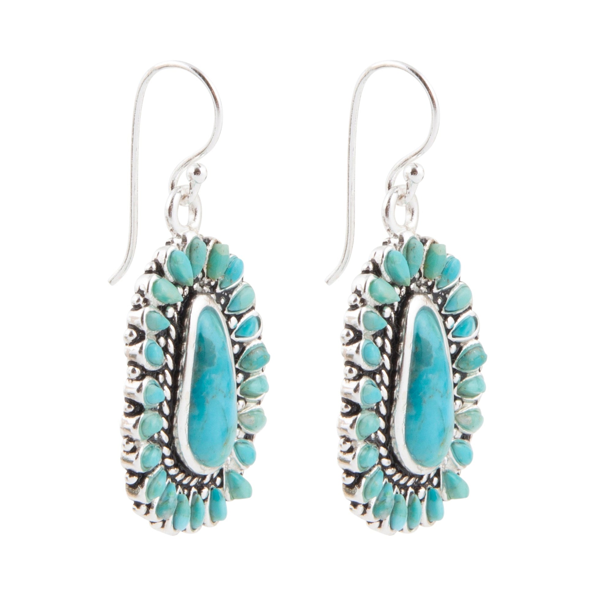 Turquoise and silver earrings on a white background