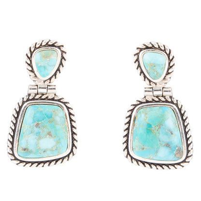 Turquoise stone earrings with silver frames on a white background