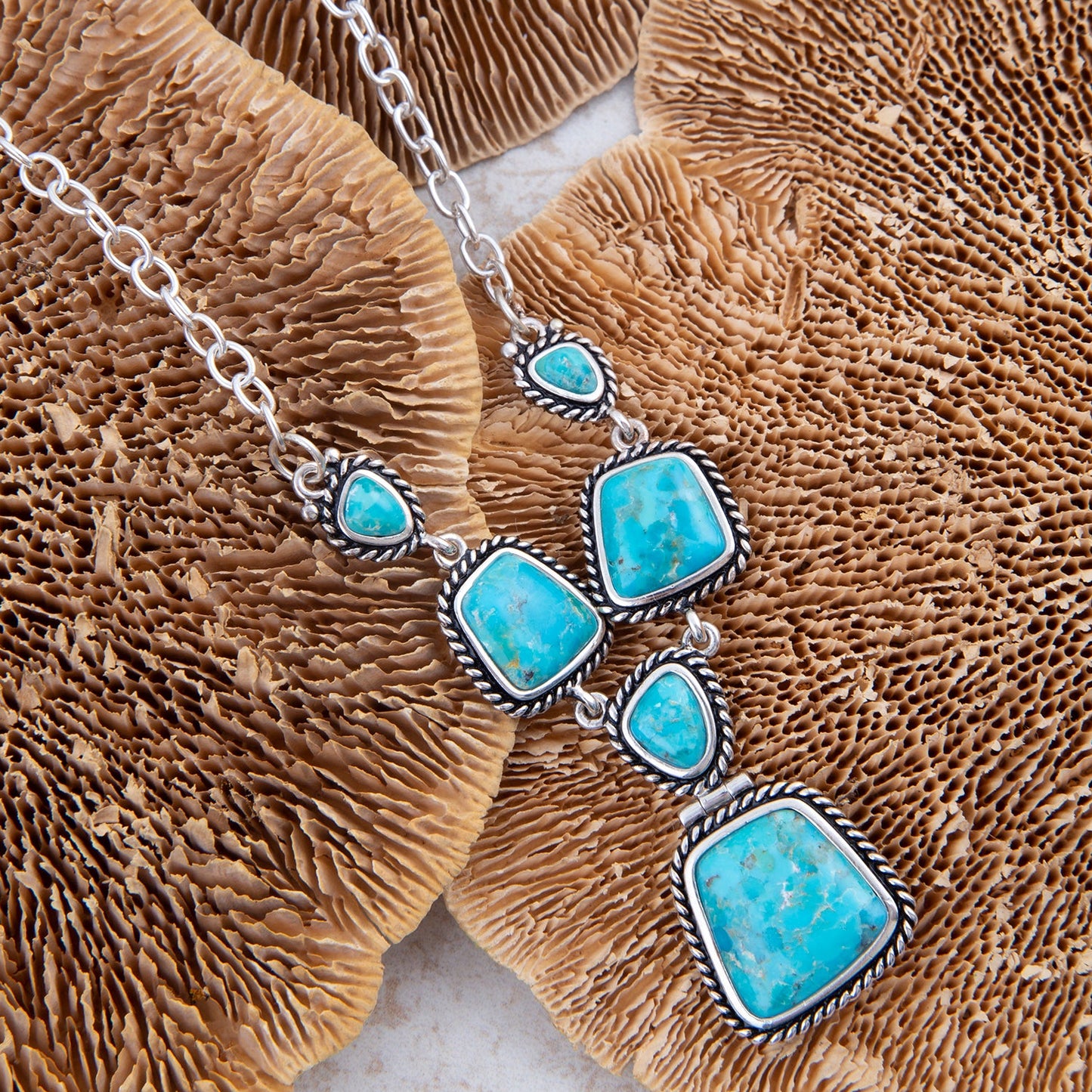 Necklace with turquoise stones on a brown coral background