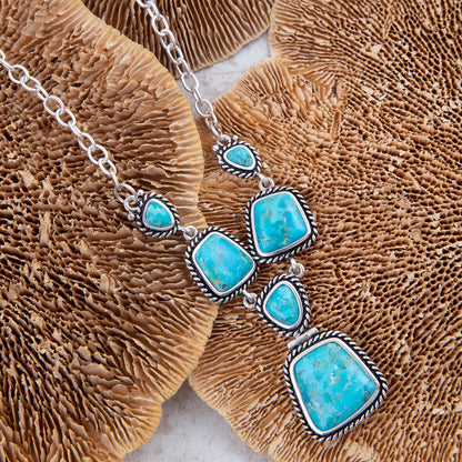 Necklace with turquoise stones on a brown coral background