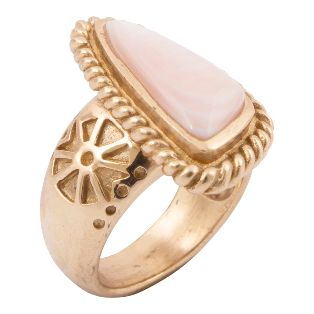 Gold ring with a pink stone on a white background