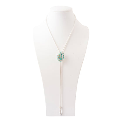 A white cord bolo tie necklace with a knotted turquoise and white centerpiece, displayed on a white mannequin bust against a white background.