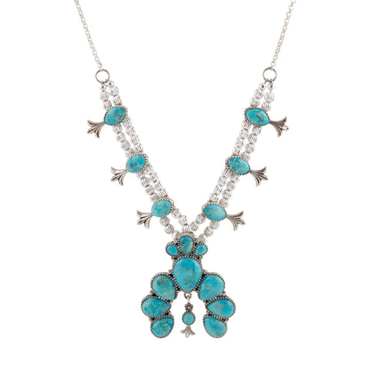 Turquoise necklace with silver accents on a white background