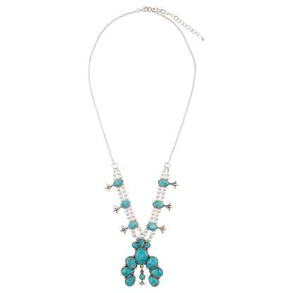 Necklace with turquoise and pearl-like beads on a white background