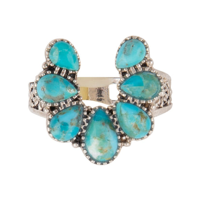 Turquoise stone ring with silver setting on a white background