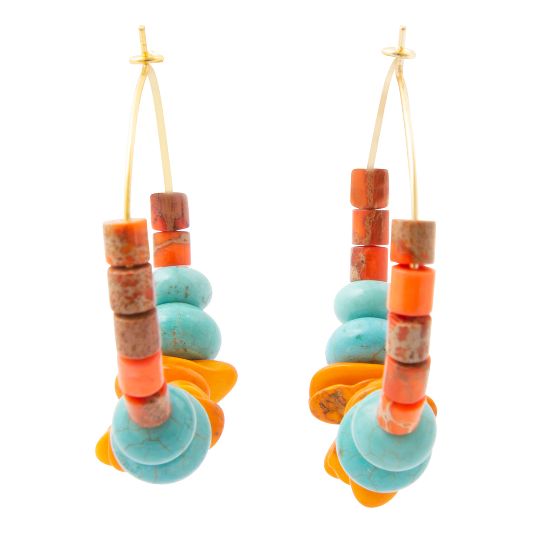 A pair of bohemian dangle earrings featuring turquoise, orange, and brown beads on gold-tone wire hooks, set against a plain white background.