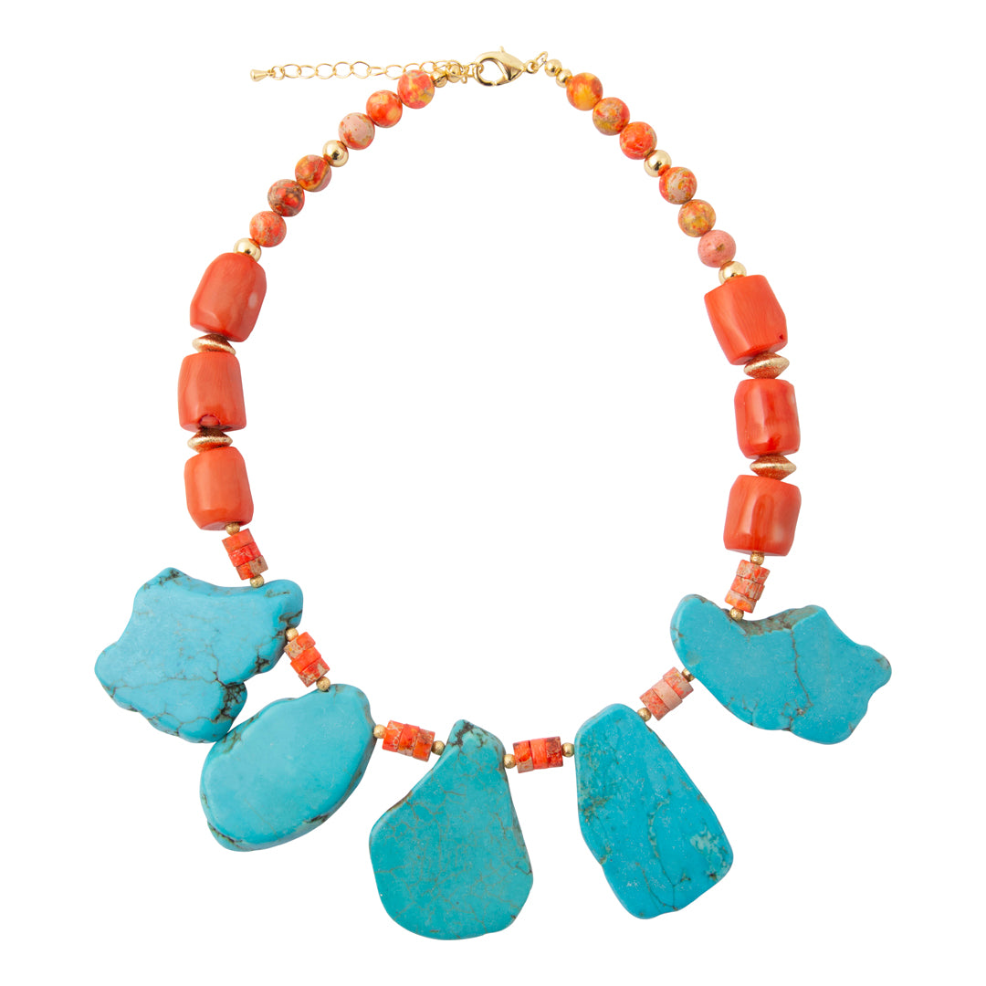 A statement necklace featuring five large turquoise-blue stone pendants at the bottom, accented by small coral-red beads and a strand of orange-red beads with gold-tone clasp and spacer rings, shown on a plain white background.