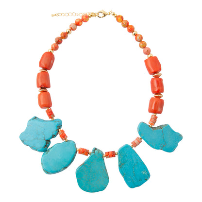 A statement necklace featuring five large turquoise-blue stone pendants at the bottom, accented by small coral-red beads and a strand of orange-red beads with gold-tone clasp and spacer rings, shown on a plain white background.