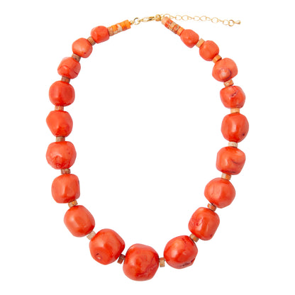 A coral-red beaded necklace with chunky, rounded beads separated by small gold spacer rings, completed with a gold-tone clasp and extender chain, shown on a plain white background.