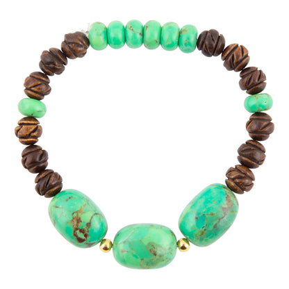 A beaded stretch bracelet featuring large green turquoise-like oval beads at the bottom, smaller round green beads at the top, dark brown textured round beads on the sides, and small gold spacer beads between sections, shown on a plain white background.