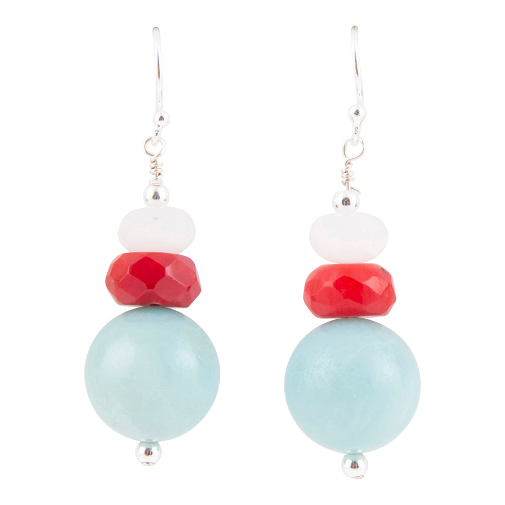A pair of silver dangle earrings featuring a stacked bead design with a large light blue bead, a faceted red bead, a small white bead, and a silver hook on a solid white background.