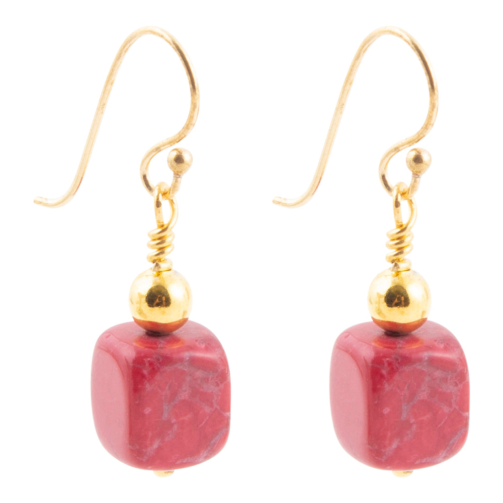 A pair of gold fishhook drop earrings featuring polished square red jasper beads with natural white veining, set against a plain white background.