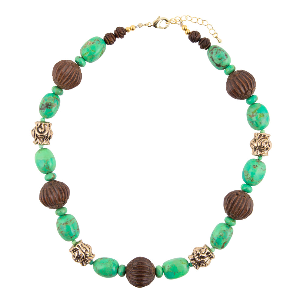 A beaded statement necklace featuring textured dark brown wooden beads, polished turquoise-green oval beads, and antique gold-toned filigree spacers, displayed on a clean white background.