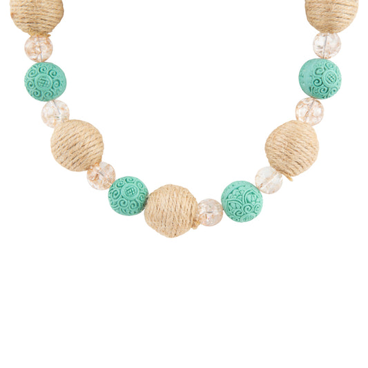 A beaded necklace featuring natural jute-wrapped beads, textured turquoise-green round beads with carved patterns, and clear faceted crystal beads, shown against a plain white background.