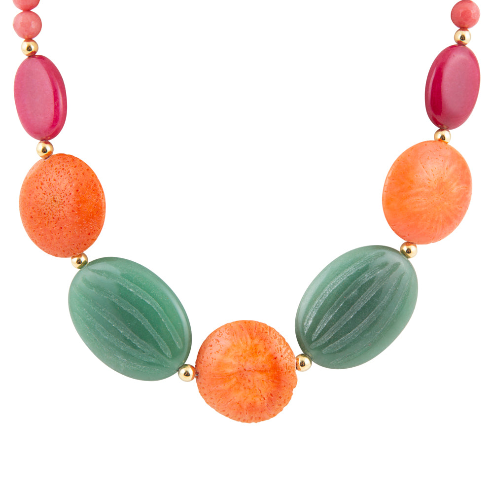 A beaded necklace featuring large oval beads in vibrant orange, textured sage green, and deep pink, separated by small gold spacer beads, shown on a solid white background.