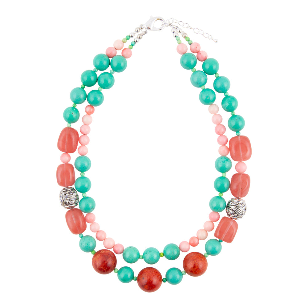 A multi-strand beaded necklace featuring turquoise green, coral red, and light pink beads, accented with two silver textured spacers and a silver clasp, shown on a plain white background.