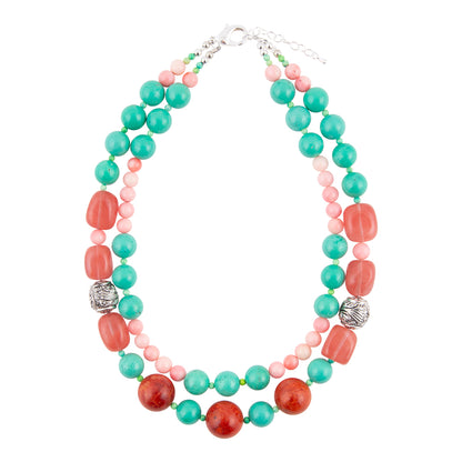 A multi-strand beaded necklace featuring turquoise green, coral red, and light pink beads, accented with two silver textured spacers and a silver clasp, shown on a plain white background.