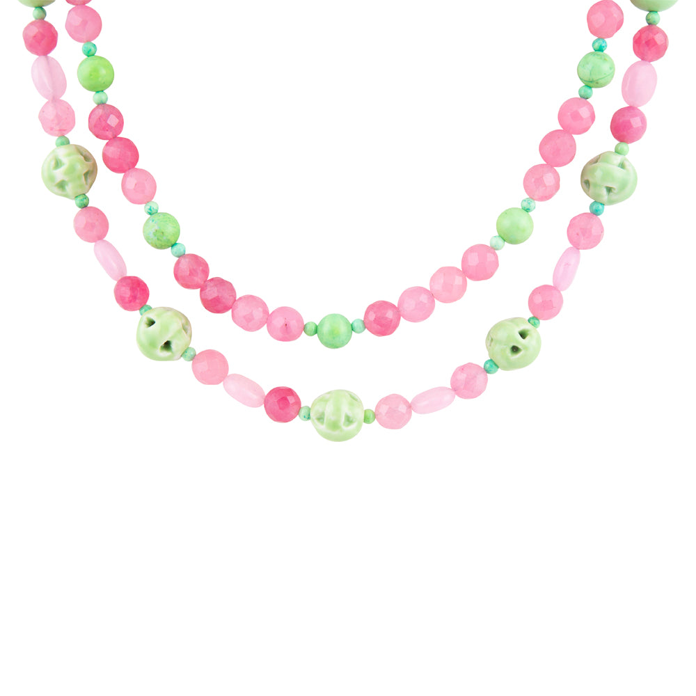 A double-strand beaded necklace featuring alternating pink and light green beads, including smooth round beads, faceted oval beads, and larger marbled green-and-white decorative beads, shown against a plain white background.
