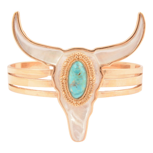 Bull skull bracelet with turquoise stone and gold accents on a white background