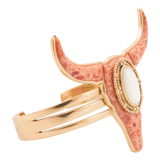 Gold and pink horned bracelet on a white background
